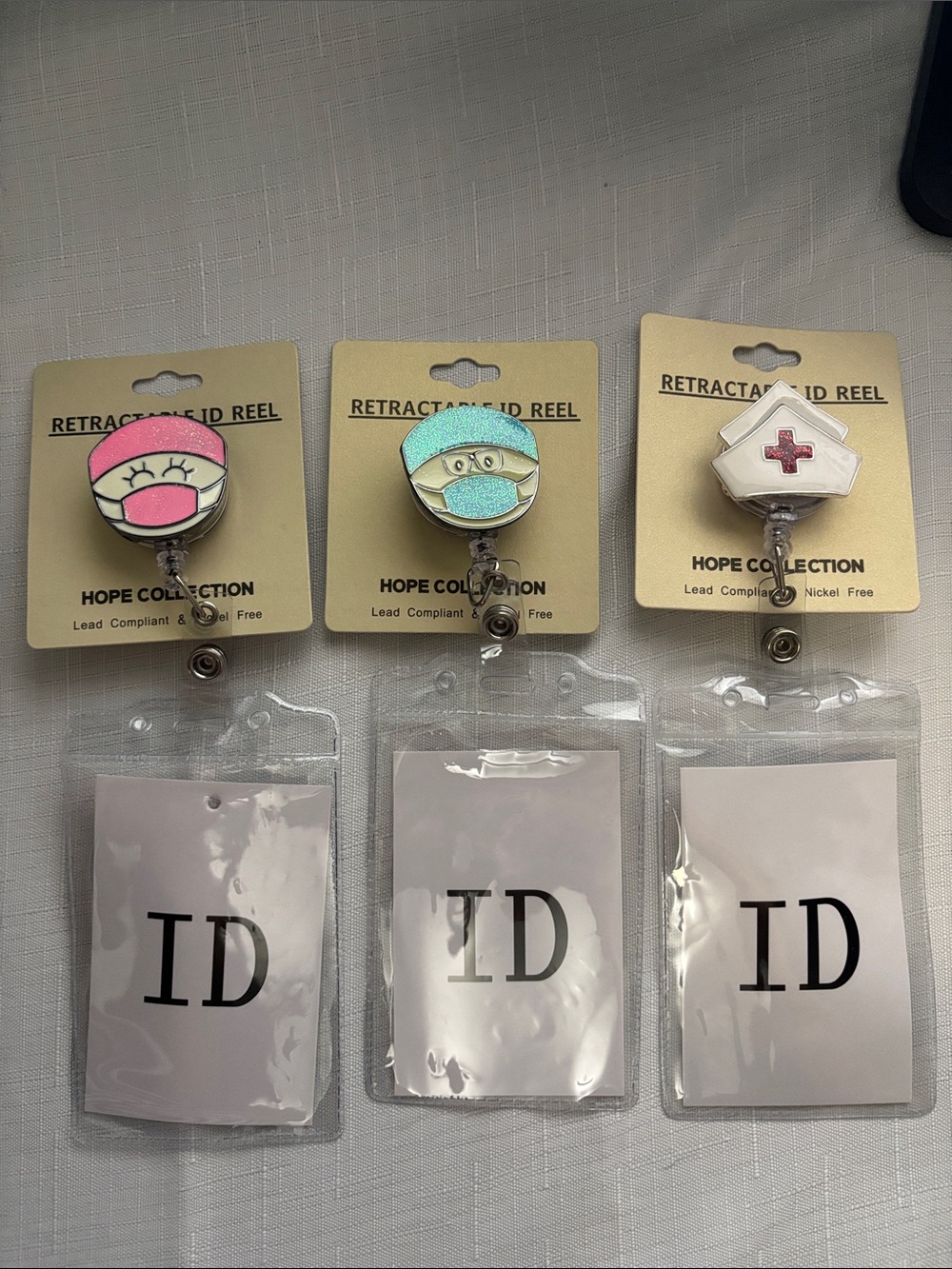 3 Nurse Badge Reels with Pink, Teal, and White Tops